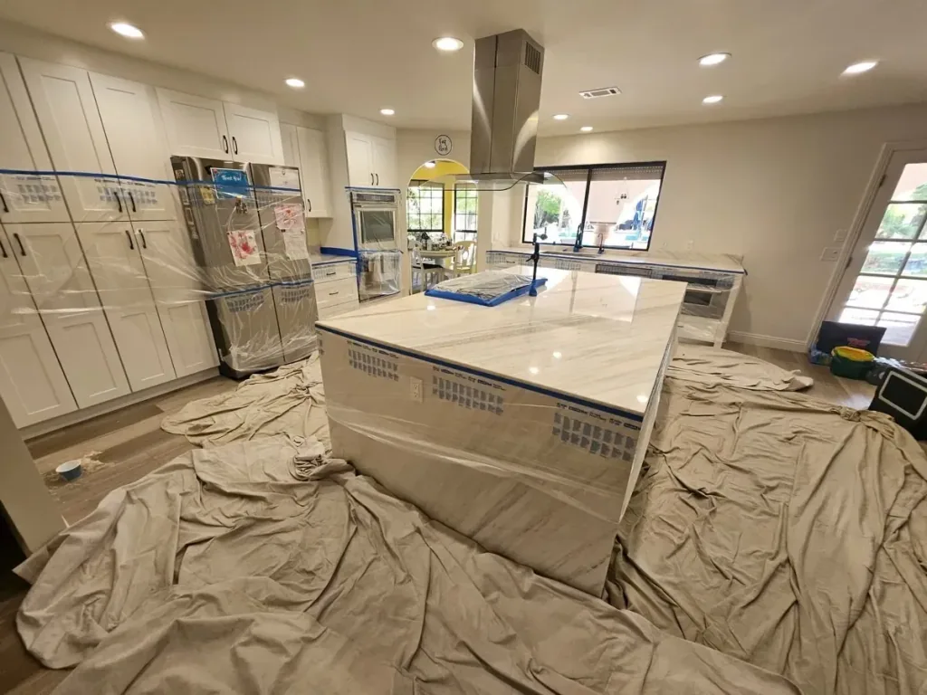 Protected stone kitchen island during professional countertop polishing