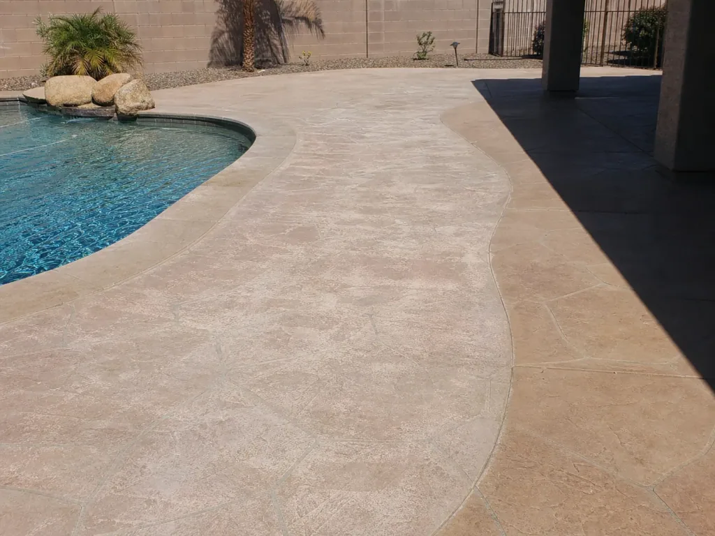 Faded and uneven color across a sun-exposed Arizona pool deck