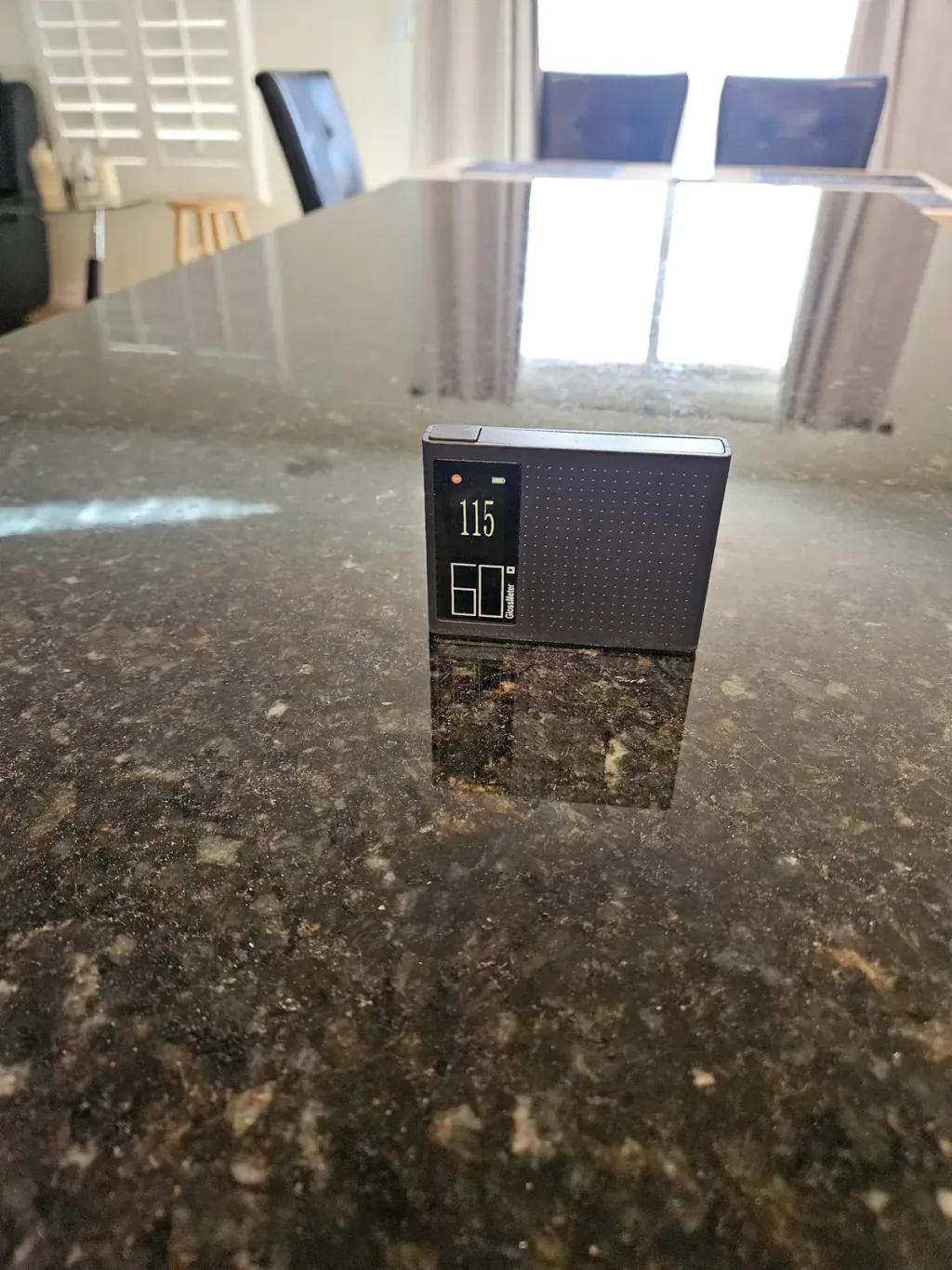 Gloss meter reading 115 on the same granite kitchen after polishing