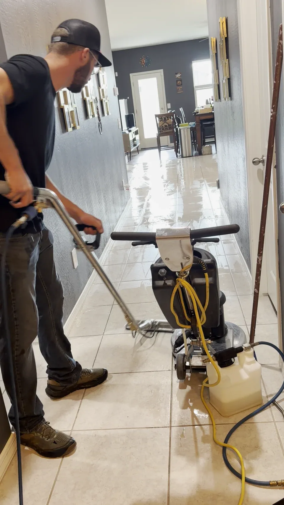 Justin Brevik operating restoration equipment on a tile floor