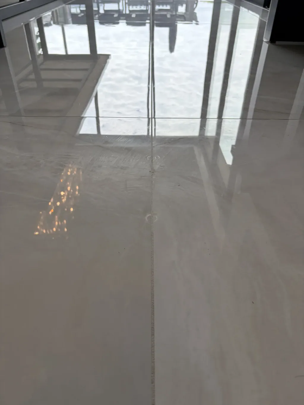 Marble floor with natural veining and a reflected window