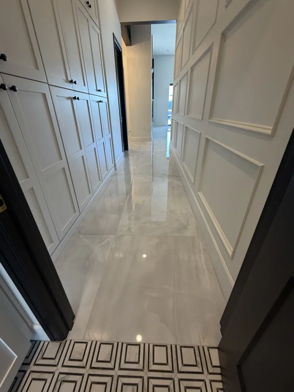 Finished marble floor around cabinetry and adjoining rooms