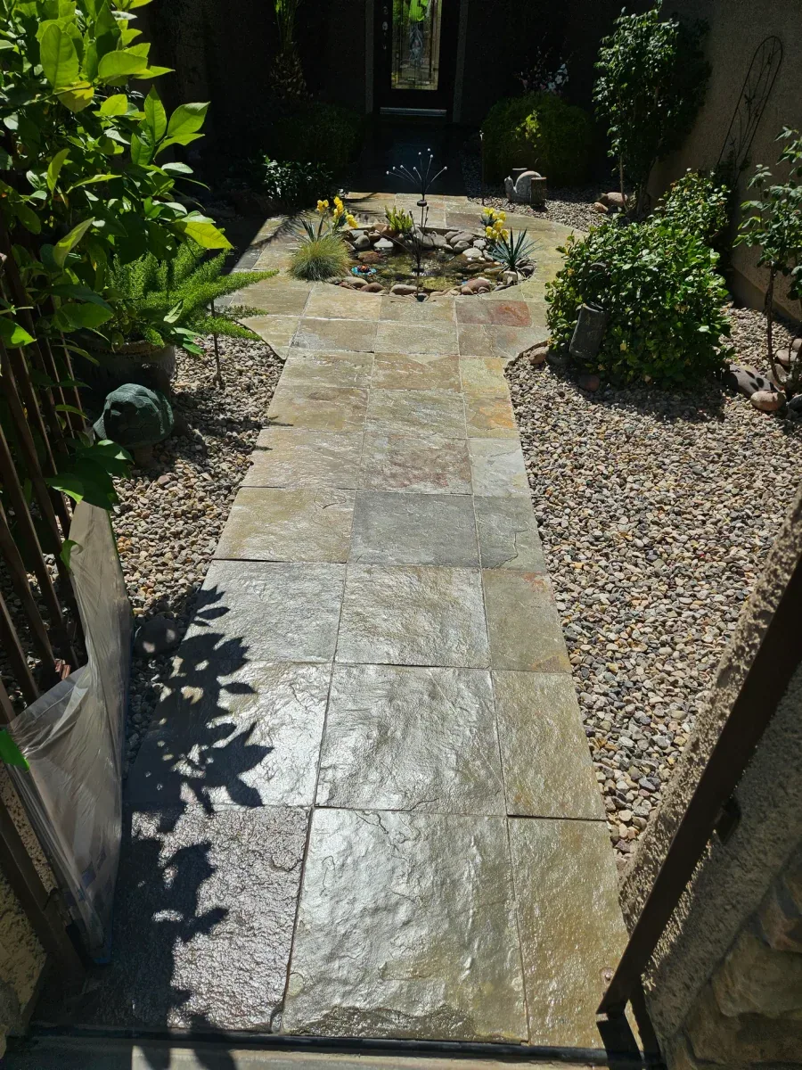 The same paver walkway after cleaning and sealing, the gold and rust tones in the stone reading clearly again