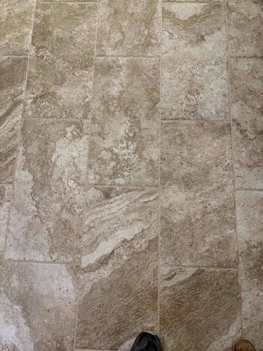 Filled cross-cut travertine surface with soft color variation and repaired natural voids