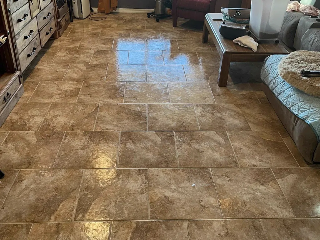 Travertine tile floor in an East Valley living room after cleaning, reflecting window light across even grout joints