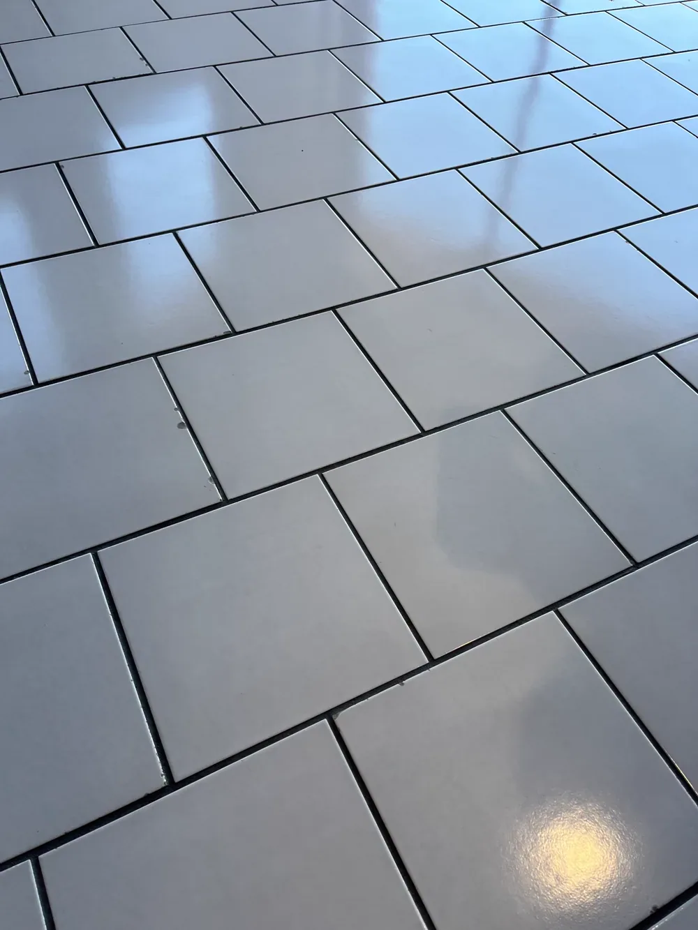 Light commercial tile floor with dark grout joints cleaned to an even tone