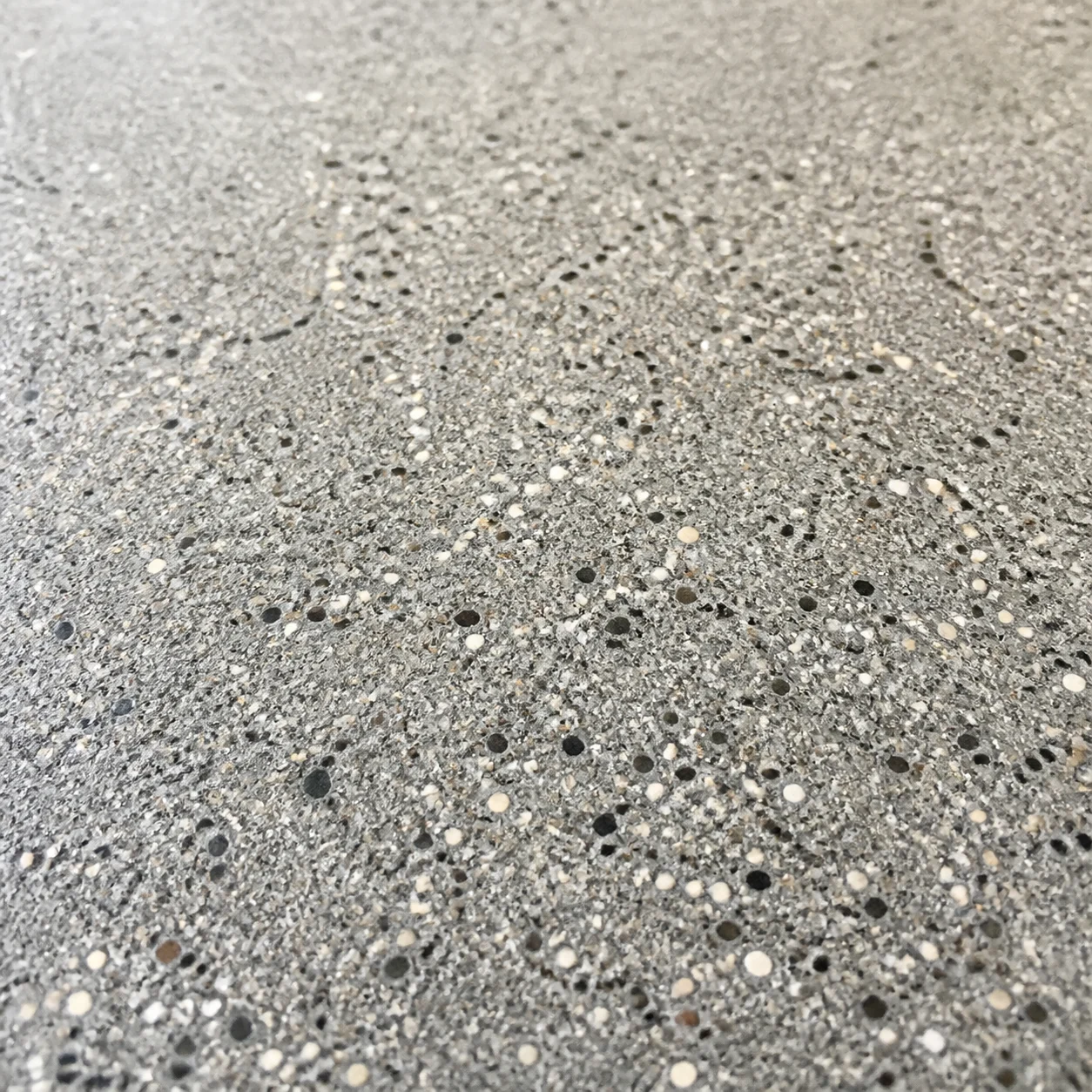 Representative close-up of concrete with fine salt-and-pepper aggregate exposure