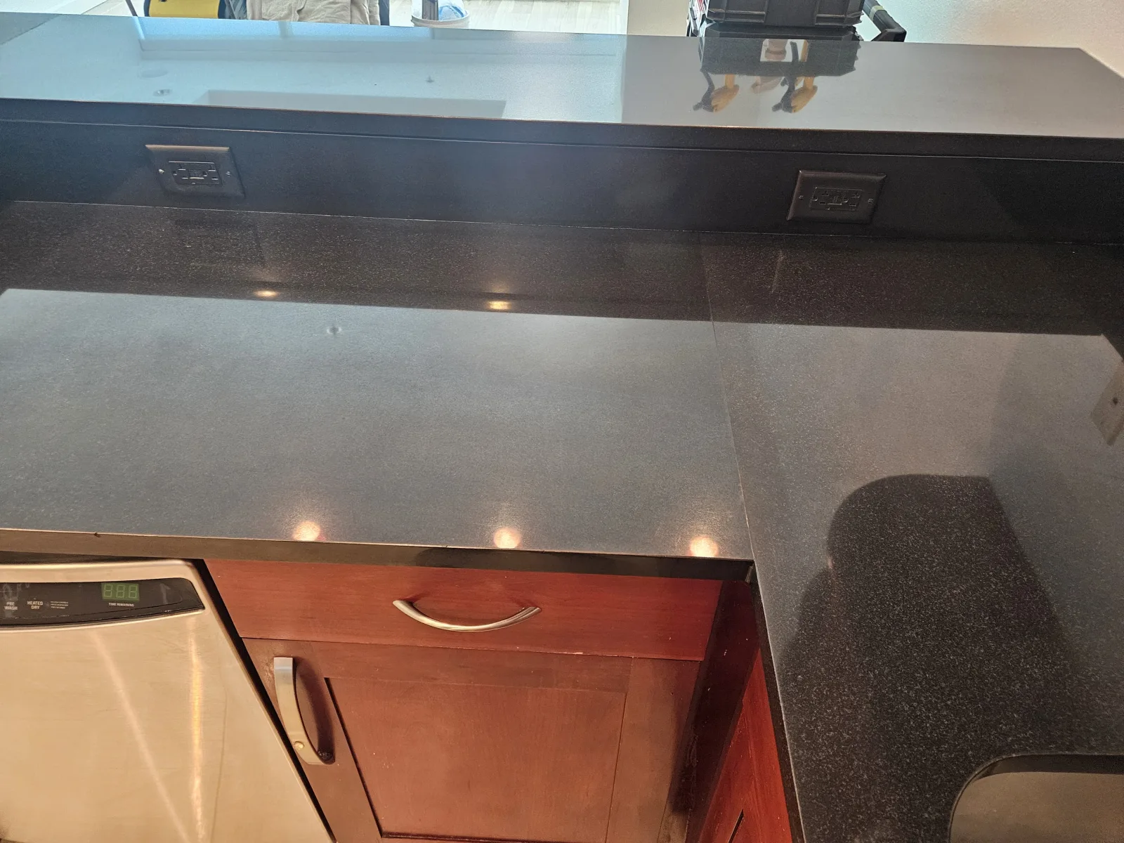 Black granite countertop showing a smooth mirror-like polished finish