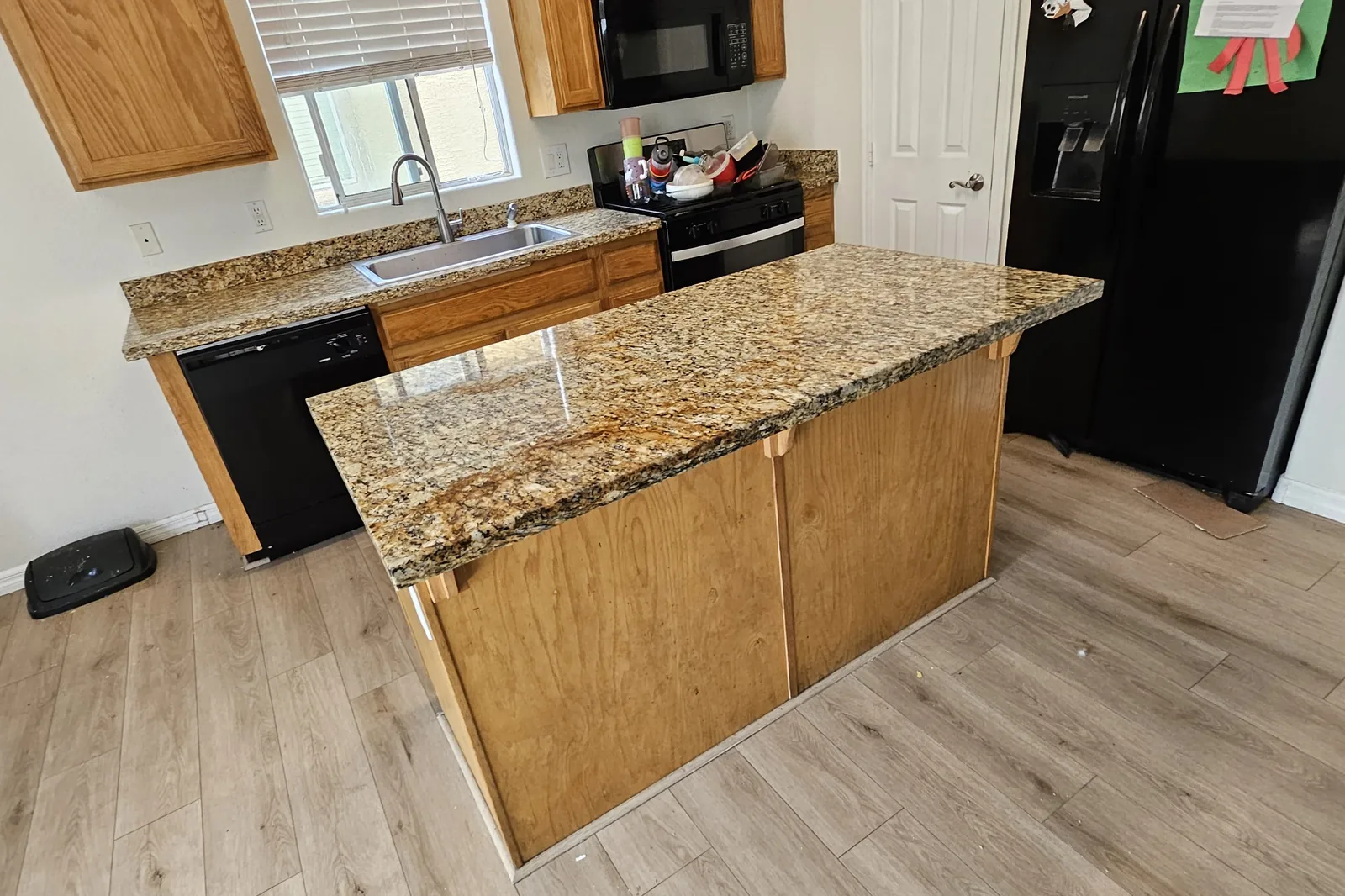 Granite kitchen island restored to an even polished finish in an East Valley home