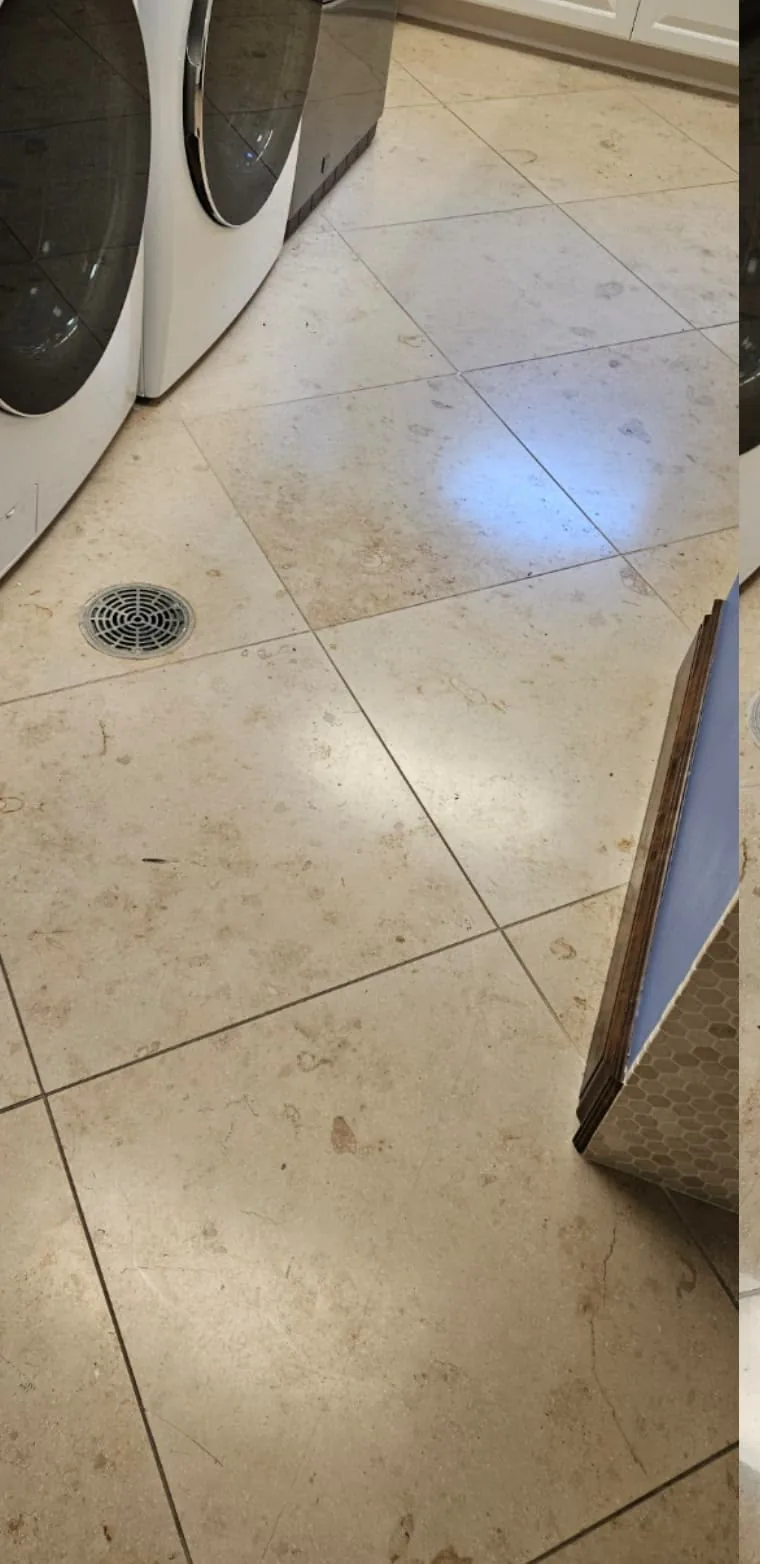 Limestone laundry room floor with a dull, flat finish before restoration