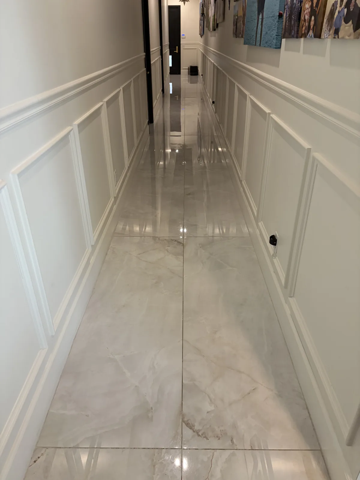 Finished polished marble floor carrying through a residential hallway