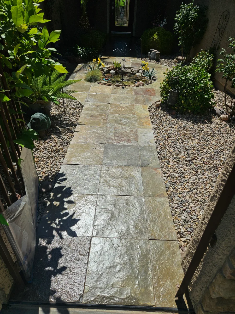 The same paver walkway after cleaning and sealing, the gold and rust tones in the stone reading clearly again