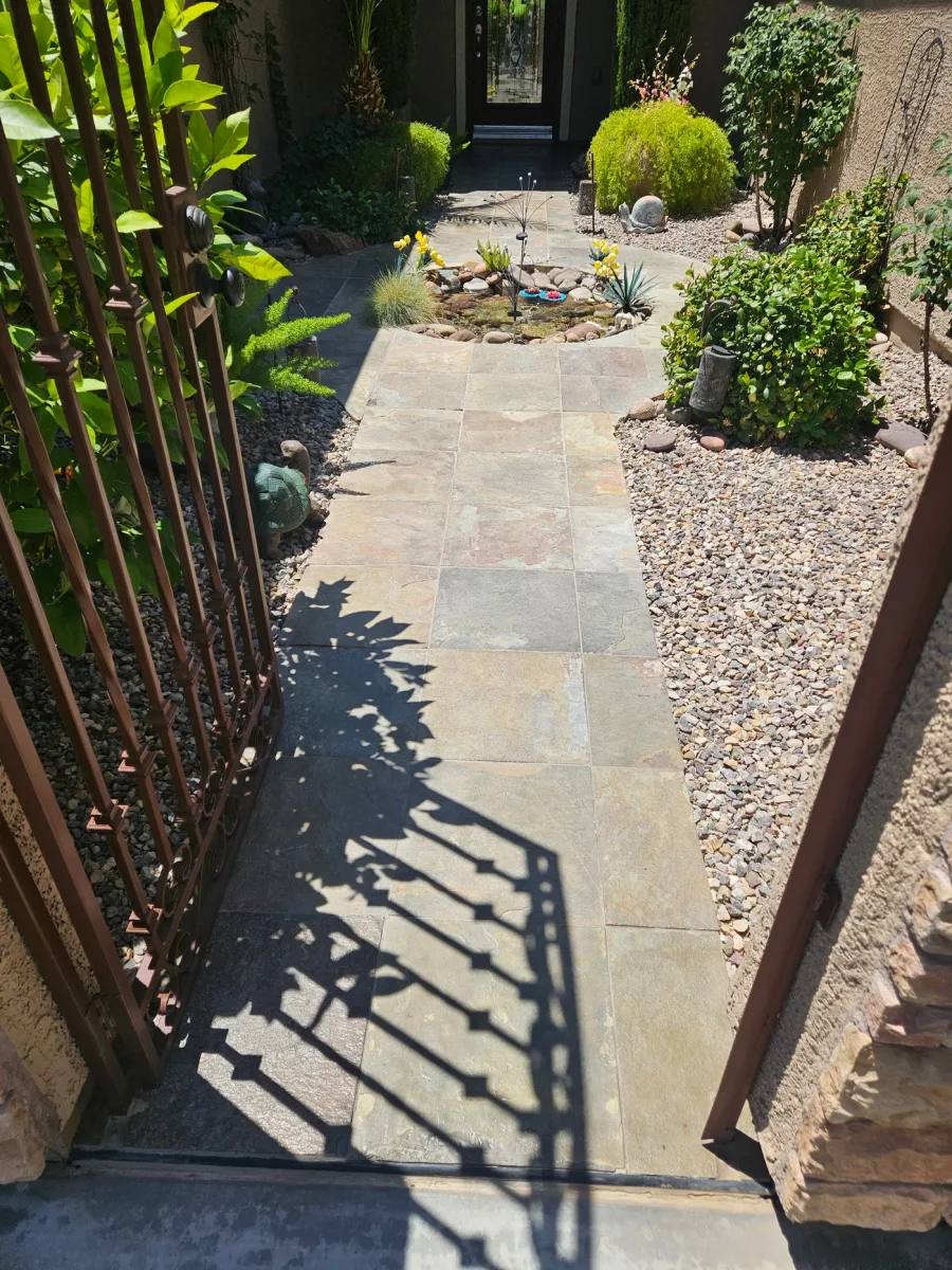 Stone paver walkway before restoration, the surface dry and grey with the color flattened out