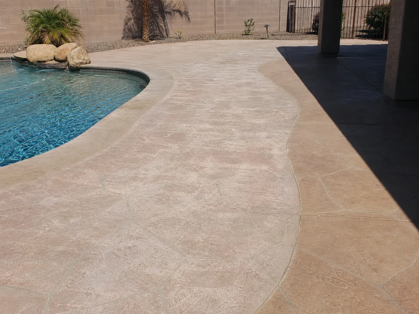Faded and uneven color across a sun-exposed Arizona pool deck