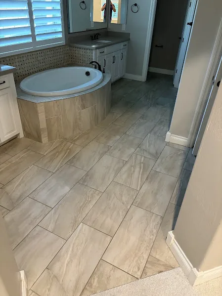 Tiled bathroom floor around a tub, an area where moisture has to be ruled out before sealing