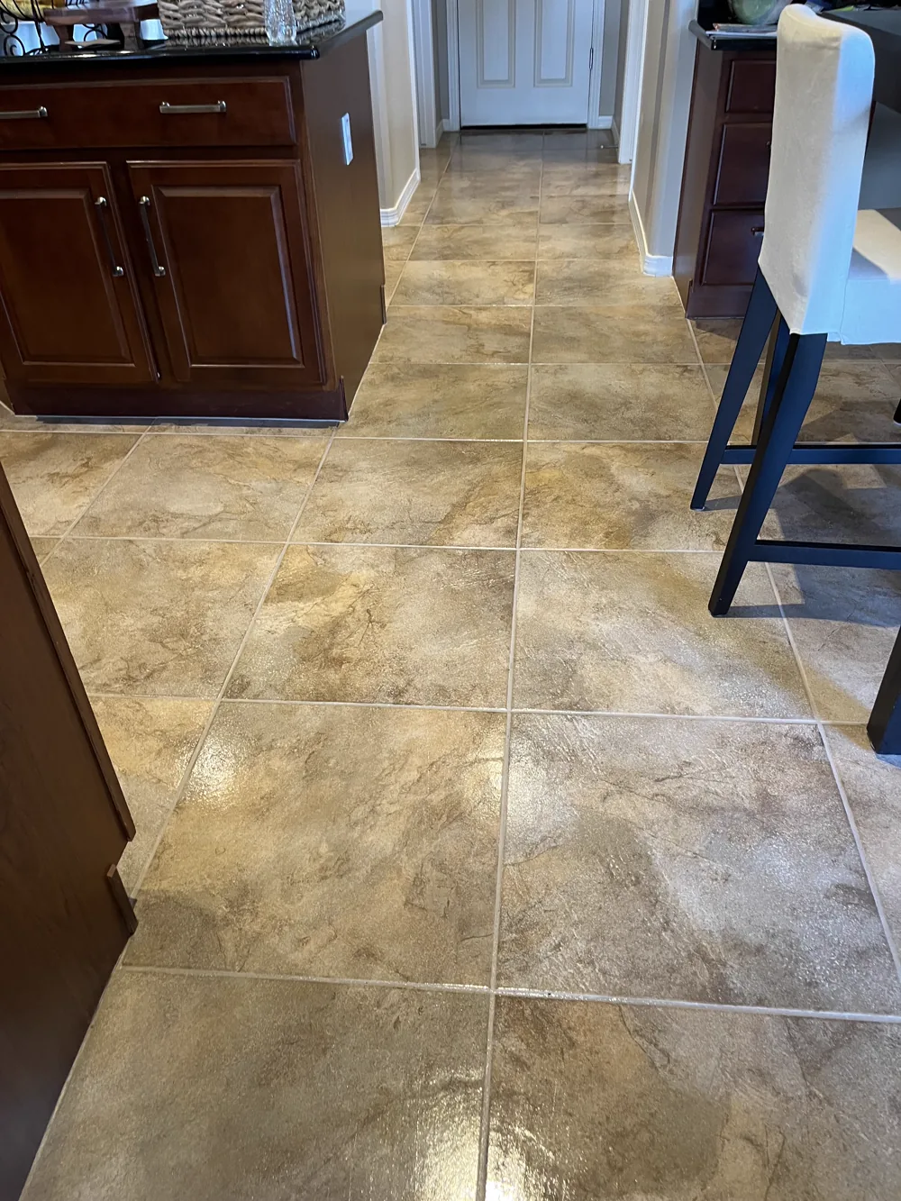 Travertine tile hallway with sound, evenly packed grout joints after repair and cleaning