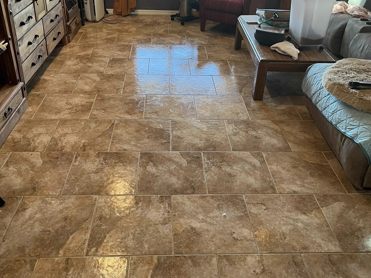 Travertine tile floor in an East Valley living room after restoration, reflecting window light across even grout joints