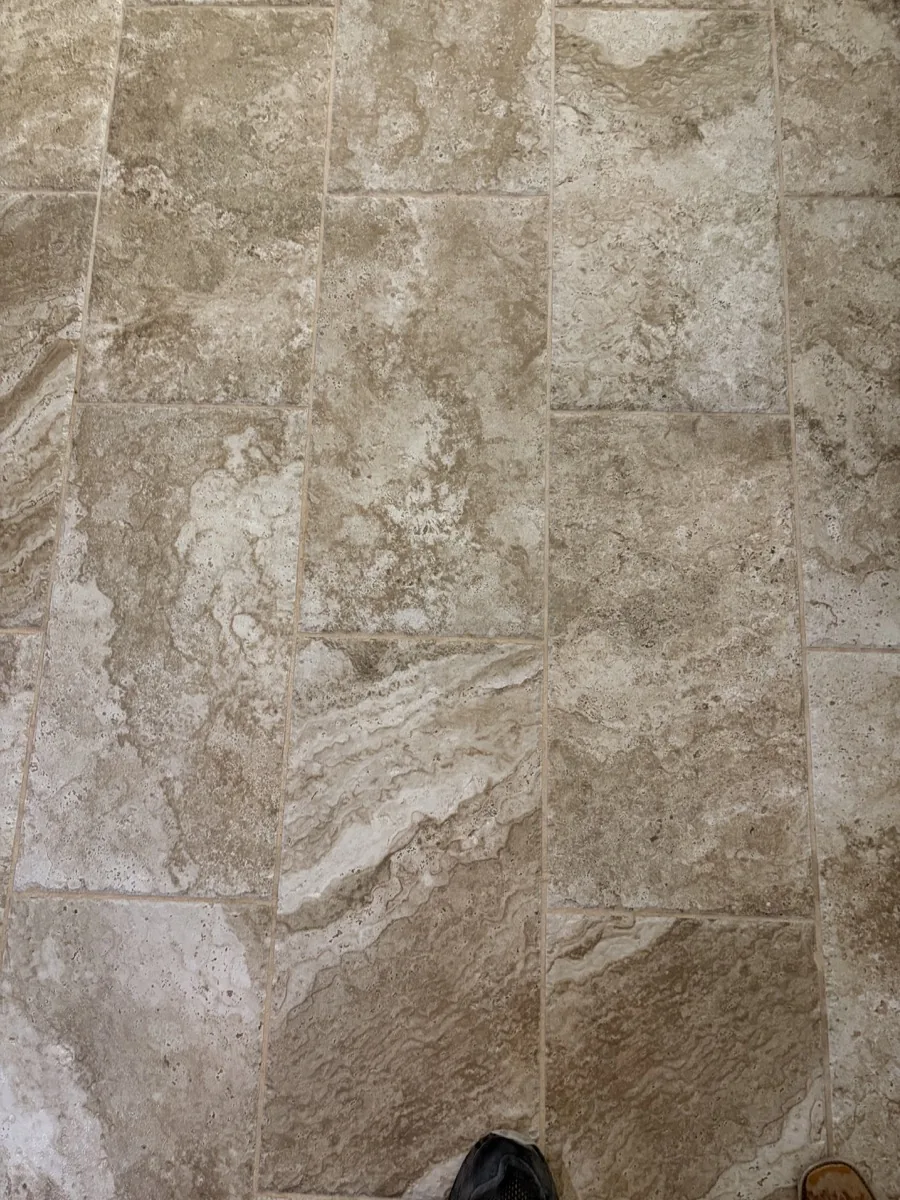 Filled cross-cut travertine surface with soft color variation and repaired natural voids