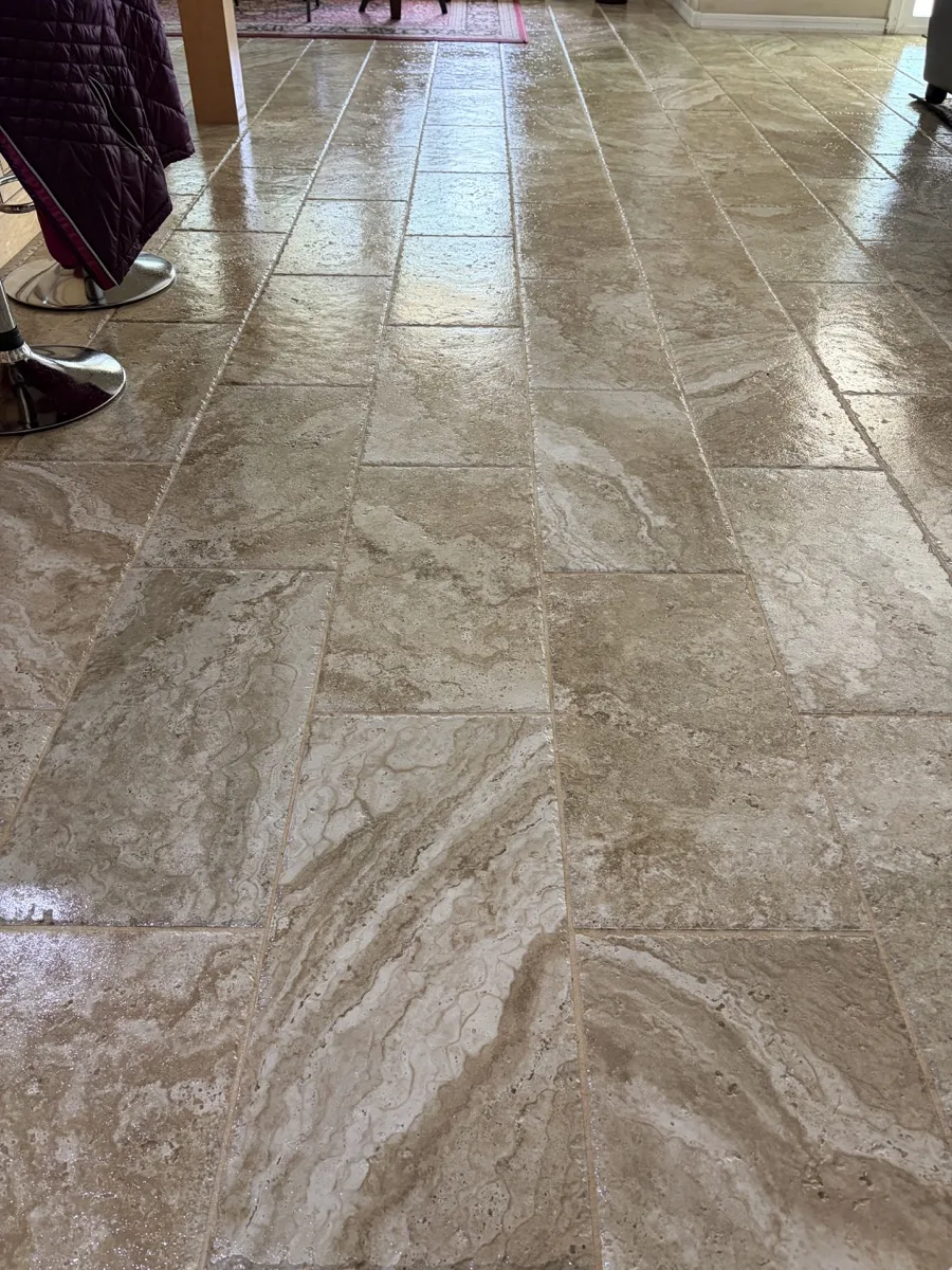 Filled cross-cut travertine floor with flowing natural movement and a reflective finish in a residential room