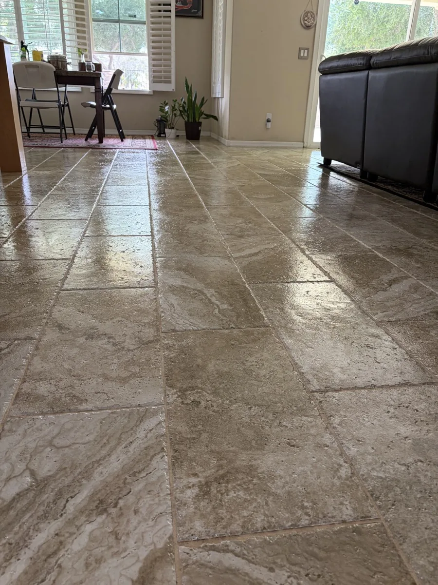 Polished travertine tile floor reflecting light across a residential room