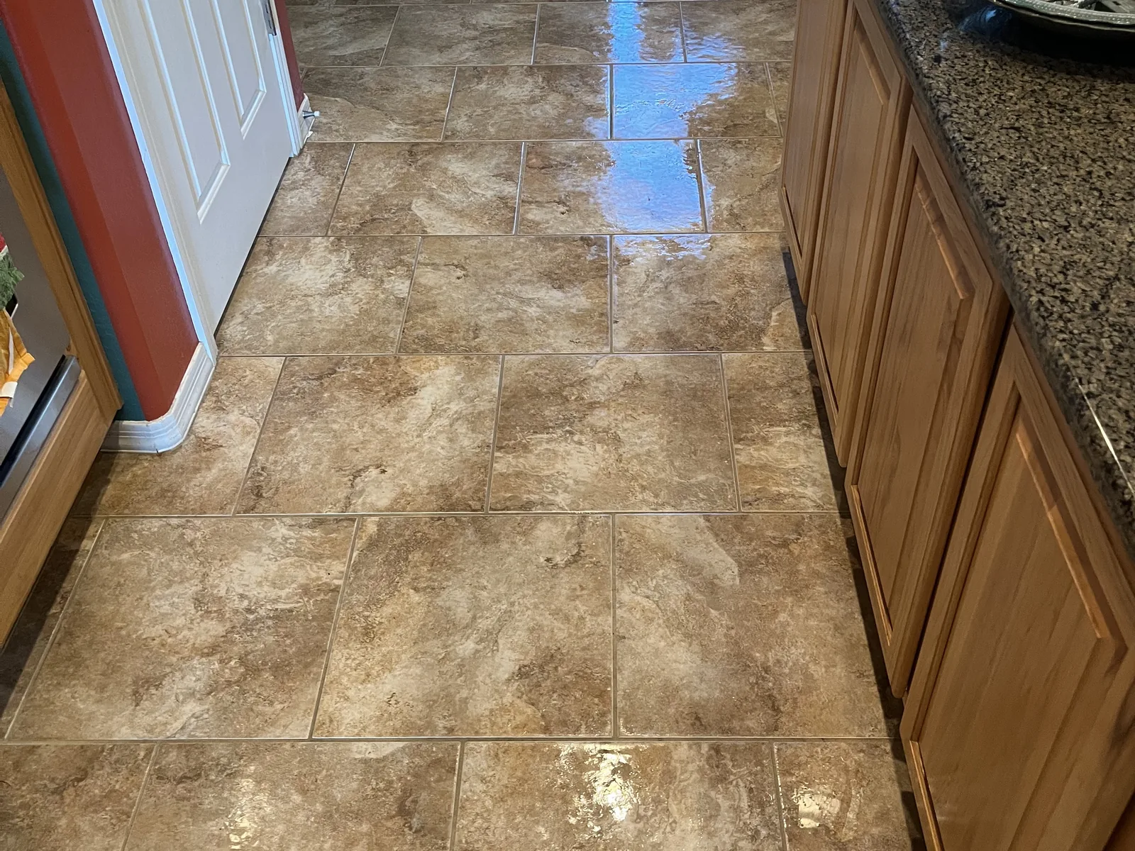 Travertine kitchen floor after honing and polishing, the tile variation clearly readable